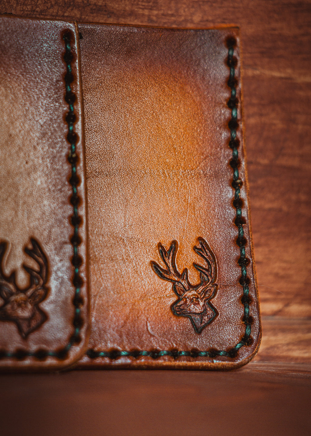 Handcrafted full grain leather card holder with buck stamp - patina detail