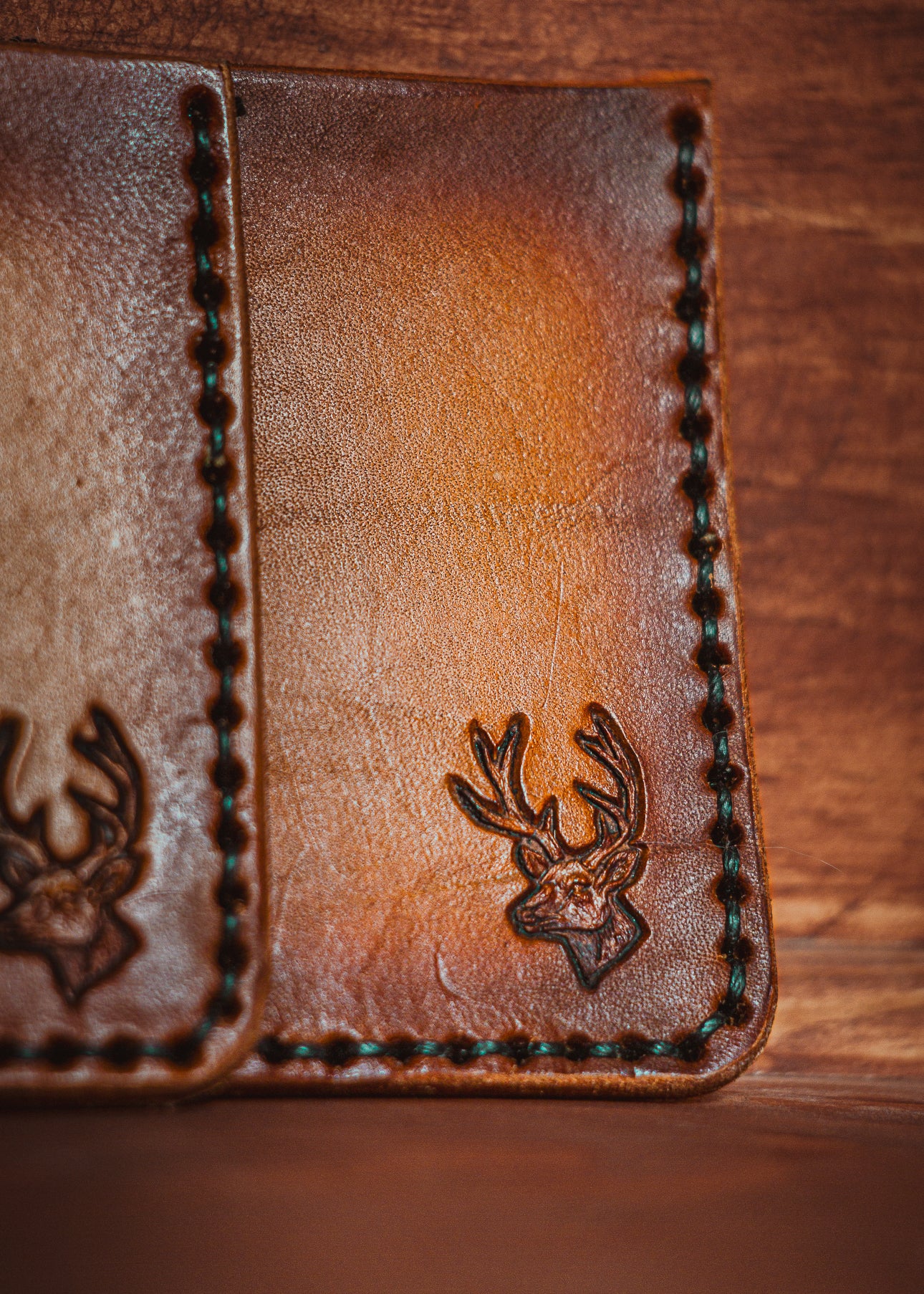 Handcrafted full grain leather card holder with buck stamp - patina detail